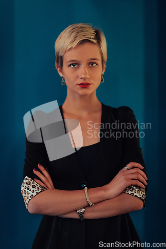 Image of Blonde business woman, successful confidence with arms crossed on modern blue mat background. Selective focus