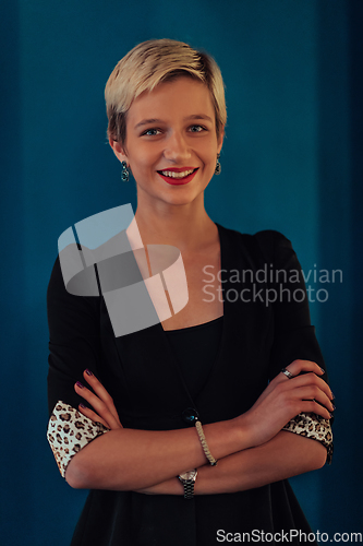 Image of Blonde business woman, successful confidence with arms crossed on modern blue mat background. Selective focus