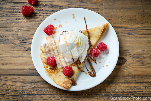 Image of crepe with ice cream and raspberries