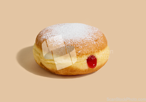 Image of jelly donut on beige background