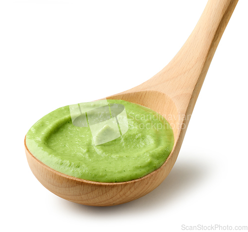 Image of green vegetable puree in wooden ladle