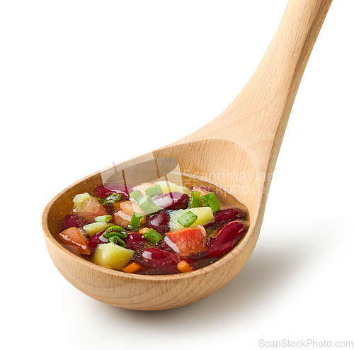 Image of vegetable soup in wooden ladle 