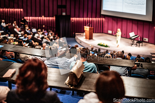 Image of Woman giving presentation on business conference event.