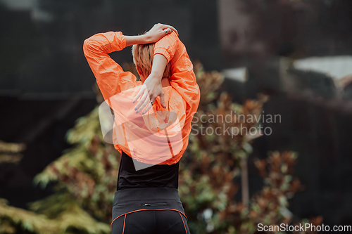 Image of Fit attractive woman in sportswear stretching before jogging. Workout, sport, activity, fitness, vacation and training concept.