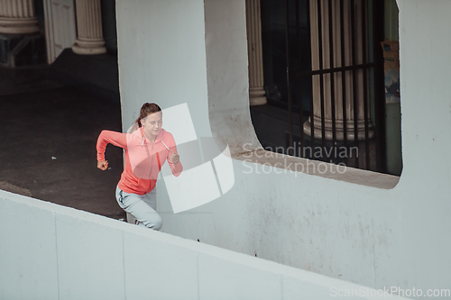 Image of Women in sports clothes running in a modern urban environment. The concept of a sporty and healthy lifestyle