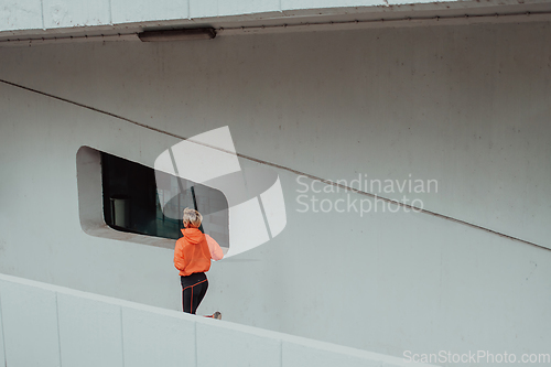 Image of Women in sports clothes running in a modern urban environment. The concept of a sporty and healthy lifestyle