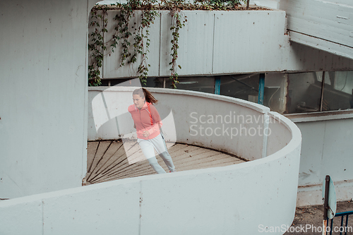 Image of Women in sports clothes running in a modern urban environment. The concept of a sporty and healthy lifestyle