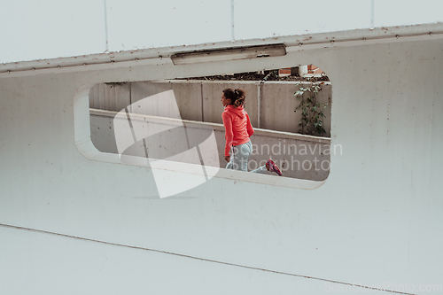 Image of Women in sports clothes running in a modern urban environment. The concept of a sporty and healthy lifestyle