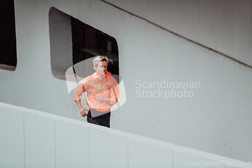 Image of Women in sports clothes running in a modern urban environment. The concept of a sporty and healthy lifestyle