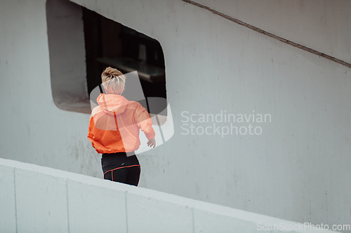 Image of Women in sports clothes running in a modern urban environment. The concept of a sporty and healthy lifestyle