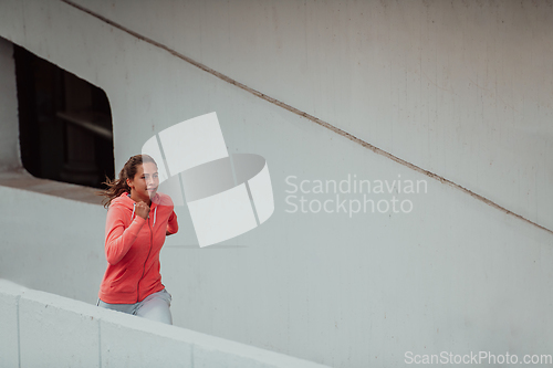 Image of Women in sports clothes running in a modern urban environment. The concept of a sporty and healthy lifestyle