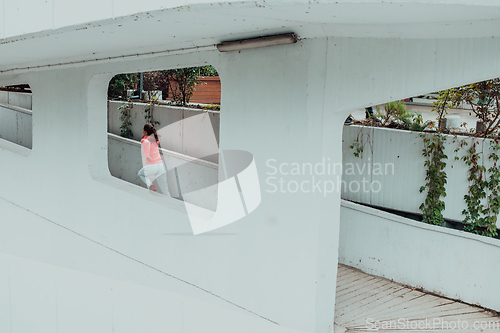 Image of Women in sports clothes running in a modern urban environment. The concept of a sporty and healthy lifestyle