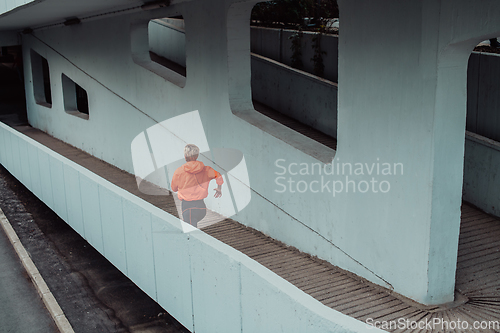 Image of Women in sports clothes running in a modern urban environment. The concept of a sporty and healthy lifestyle