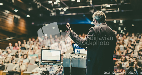 Image of Public speaker giving talk at Business Event.