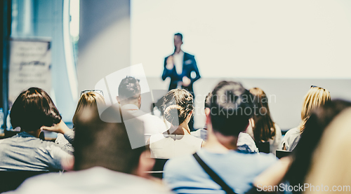 Image of Male business speaker giving a talk at business conference event.