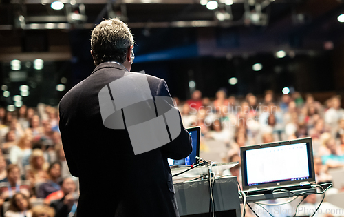 Image of Public speaker giving talk at Business Event.