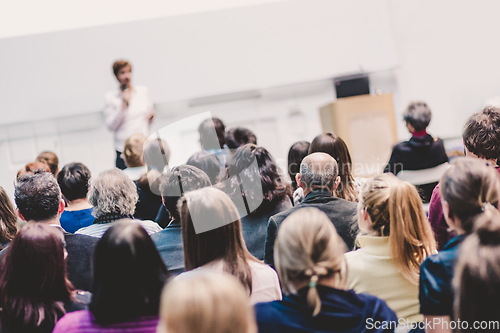 Image of Woman giving presentation on business conference event.