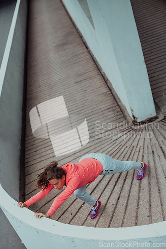 Image of Fit attractive woman in sportswear stretching before jogging. Workout, sport, activity, fitness, vacation and training concept.