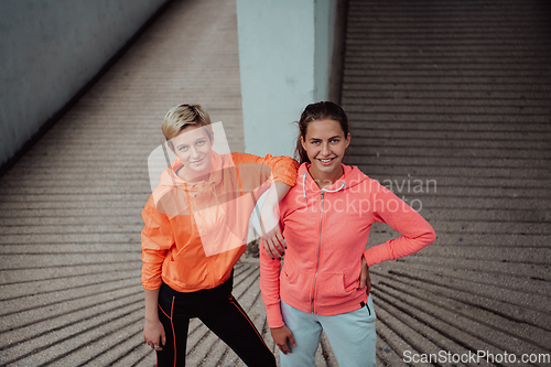 Image of Two lgbt woman resting after a hard training in an urban environment