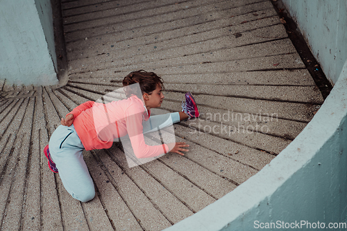 Image of Fit attractive woman in sportswear stretching before jogging. Workout, sport, activity, fitness, vacation and training concept.