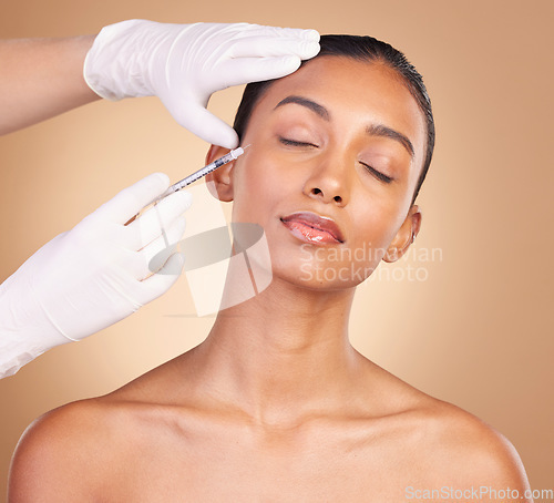 Image of Woman, face and needle with beauty and dermatology, skincare with plastic surgery on studio background. Female, hands and skin injection, cosmetic procedure with facelift treatment and eyes closed