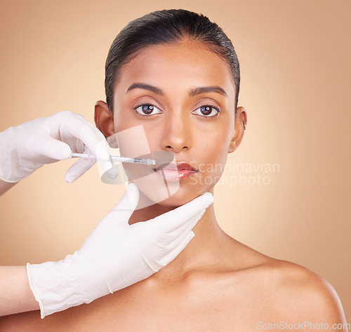 Image of Woman, face and needle in portrait with beauty and dermatology, skincare with plastic surgery on studio background. Female, hands and injection, cosmetic procedure with facelift treatment and skin