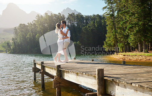 Image of Love, couple and dance at lake pier, smile and bonding together outdoors on vacation. Dancing date, having fun and happy man and woman on anniversary celebration for romantic holiday at summer creek.