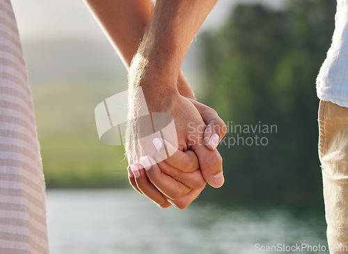 Image of Holding hands, love and couple at lake outdoors for commitment, trust and support. Romantic date, care and woman and man together for romance, bonding and affection with soulmate at creek on vacation