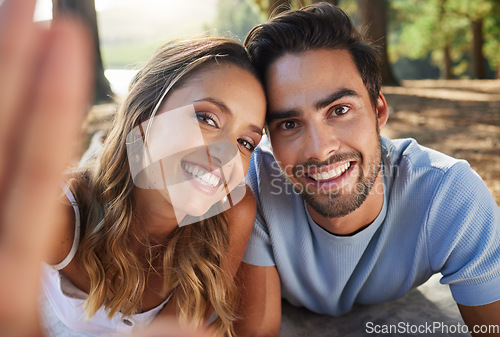 Image of Selfie, happy and portrait of a couple in nature for a memory, date and bonding. Smile, looking and a young man and woman taking a photo in the woods or forest for relationship memories together