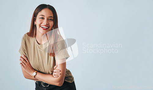 Image of Portrait, mockup and laughter with an arms crossed woman in studio having fun on a gray background. Comic, comedy and humor with an attractive young female standing indoor feeling playful or carefree