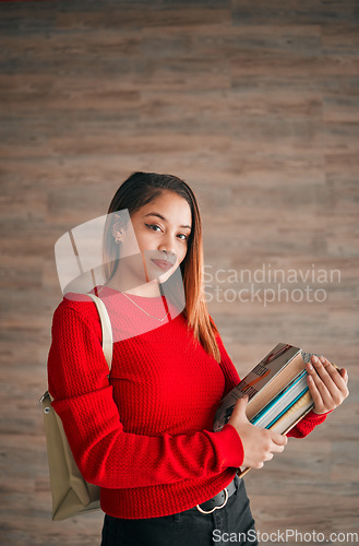 Image of Serious, books and education with portrait of woman on wall background for learning, college and scholarship. University, knowledge and academic with female student for school, intelligent and campus