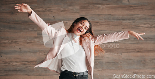 Image of Freedom, dance and happy with woman on wall background for crazy, celebration and confidence. Winner, pride and music with young female and dancing in studio for happiness, energy and carefree