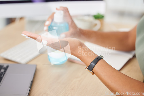 Image of Hands, covid or sanitizer and a business woman cleaning for hygiene or compliance with regulations in the office. Safety, desk or bacteria and a female employee spraying her hand with disinfectant