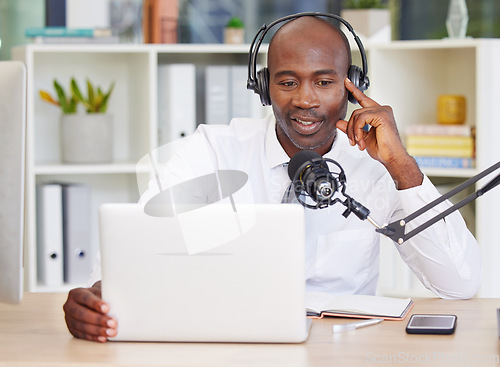 Image of Laptop, headphones and black man with microphone for podcast, recording or live streaming in office. Business, computer and male entrepreneur or influencer with mic for content creation or radio host