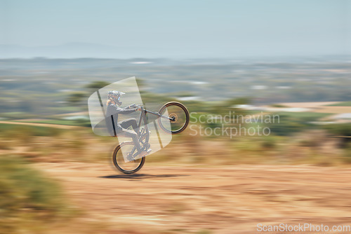 Image of Extreme sports, bicycle and man cycling in the countryside for fitness, stunt and freedom. Nature, biking and sporty male cyclist training, practice and speed, action and free on Mexico dirt road