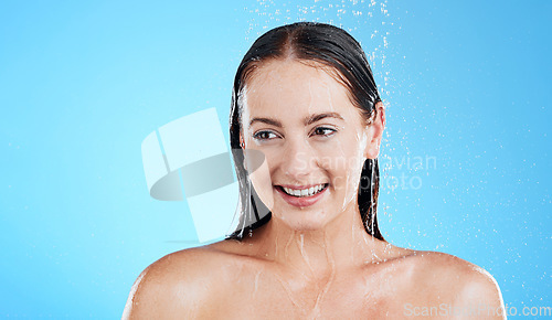 Image of Water, shower and happy woman washing in studio for skincare, wellness and clean body for self care. Face of female model, splash or drop for cleaning, hygiene and cosmetics on blue background mockup