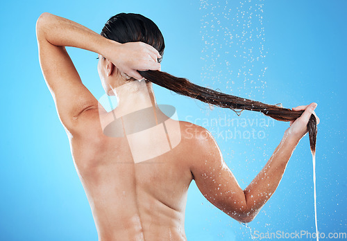 Image of Shower, woman rinsing hair from back and blue background in morning bathroom routine, hygiene and studio mockup. Healthy haircare, wellness and fresh beauty model cleaning in water with mock up space