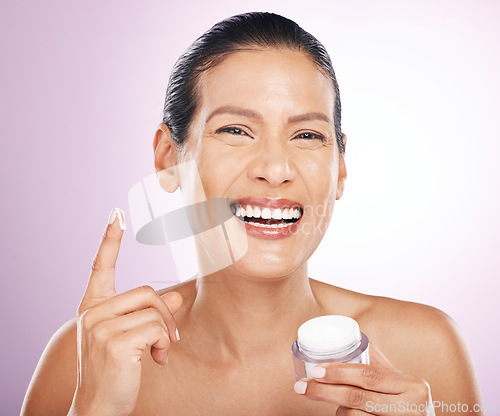 Image of Face, cream jar and skincare of woman in studio isolated on purple background. Mature portrait, cosmetics and funny female model with dermatology lotion, creme or moisturizer product for healthy skin