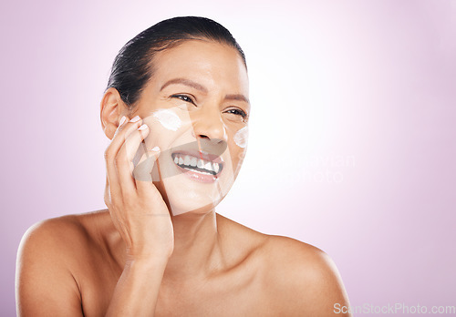 Image of Face smile, cream and skincare of woman in studio isolated on a purple background. Mature, thinking and happy female model with dermatology lotion, creme and moisturizer cosmetics for healthy skin.