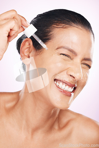 Image of Face smile, skincare serum and woman in studio isolated on a purple background. Dermatology, cosmetics and happy mature female model apply hyaluronic acid, retinol or essential oil for anti aging.