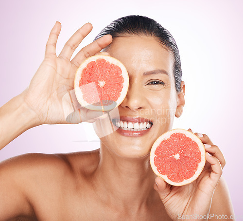 Image of Face smile, grapefruit and skincare of woman in studio isolated on a purple background. Natural cosmetics, portrait and happy mature female model with fruit for vitamin c, nutrition or healthy diet.