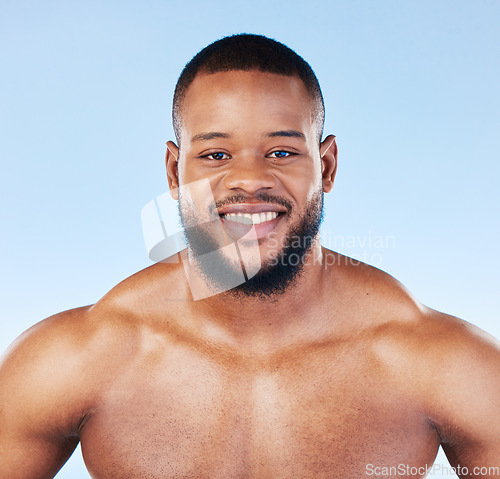 Image of Body care, portrait and man in studio for cleaning, grooming or hygiene against blue background. Face, shower and male wellness model relax for beauty, routine and self care while posing isolated