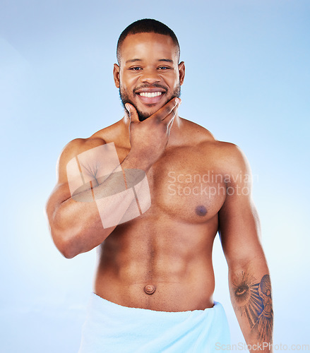 Image of Smile, shower towel and portrait of a black man with fitness happiness from bodybuilder muscle. Cleaning, skincare and wellness after workout and exercise with isolated, studio and blue background