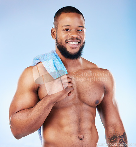 Image of Towel, shower and skincare portrait of a black man with happiness from bodybuilder muscle. Cleaning, self care and wellness from gym workout and exercise with isolated, studio and blue background