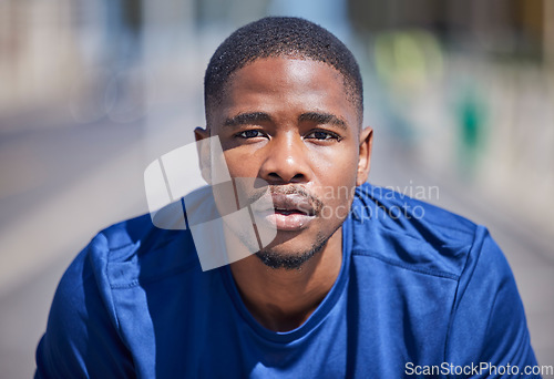 Image of Fitness, portrait and serious black man while running in the city with focus and wellness mindset. Face or male runner with sports routine preparation for cardio, exercise or intense workout