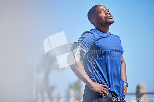 Image of Fitness, exercise and tired man runner outdoors for break from training, cardio or running on blue sky background. Workout, stop and breathe by athletic guy outside for marathon, run or sport routine