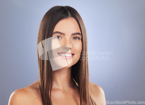 Image of Woman, beauty and hair care portrait in studio for glow, growth or healthy shine on blue background. Aesthetic female model smile for haircare, self love and cosmetic for salon or hairdresser results