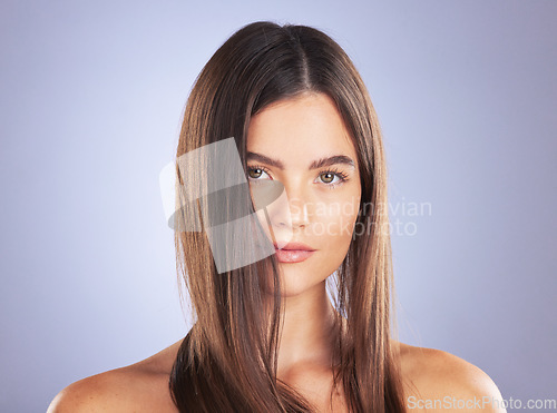 Image of Beauty, woman and hair care portrait in studio for texture, growth and healthy shine on blue background. Aesthetic female model serious about haircare, and cosmetic for salon or hairdresser results