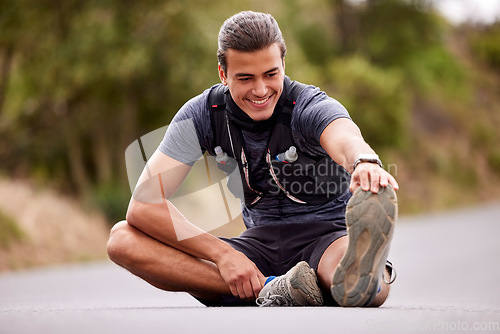 Image of Fitness, man and stretching legs for exercise, workout or training in the nature outdoors. Happy active male smile in warm up leg stretch to start sports, running or exercising on street or road