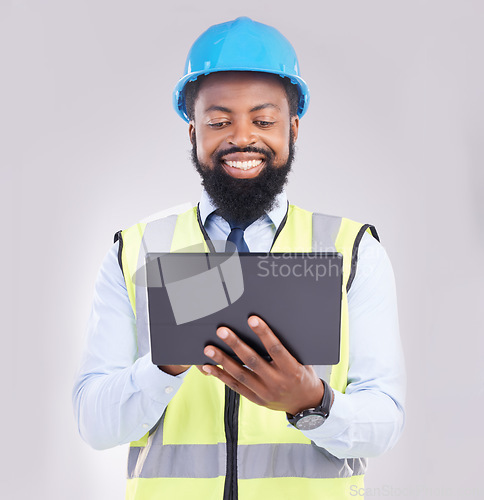 Image of Black man, engineer and tablet in studio for construction with smile for architecture, design or building. Architect, mobile touchscreen and excited face for property, development and project on app